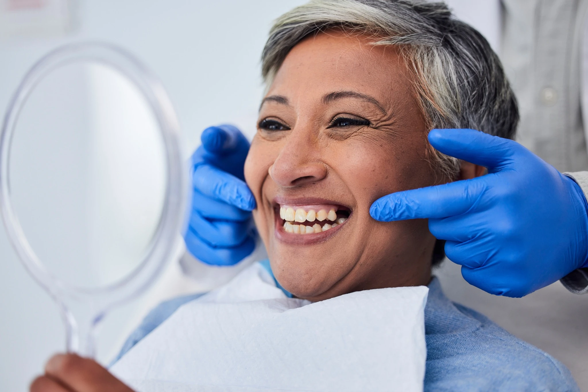 Senior woman smiling after dental implant