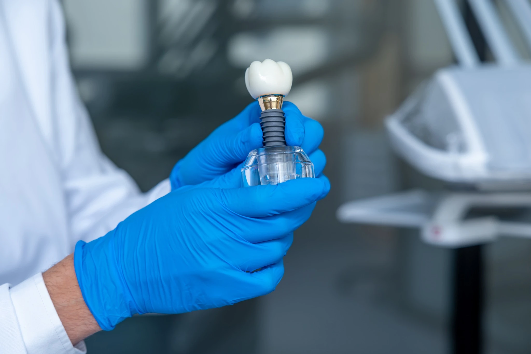 Doctor displaying dental implant crown model