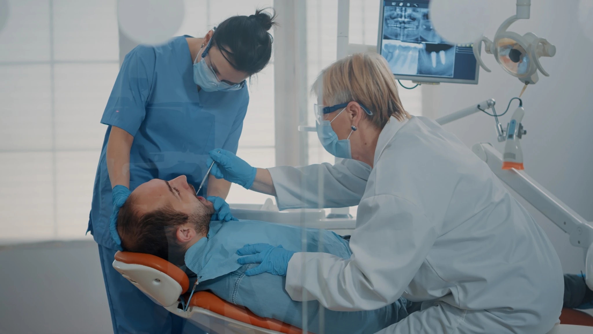 Dental team treating patient with severe toothache