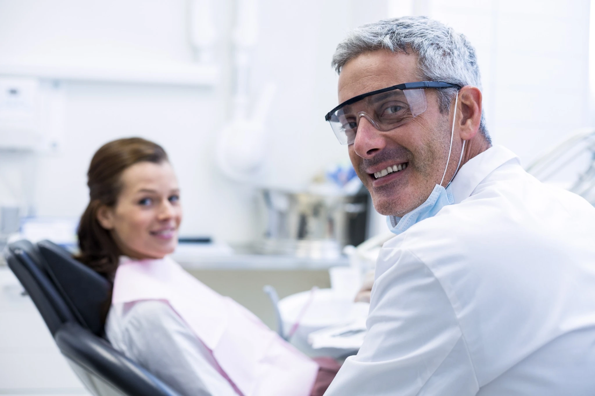 Dentist and female patient after whitening session