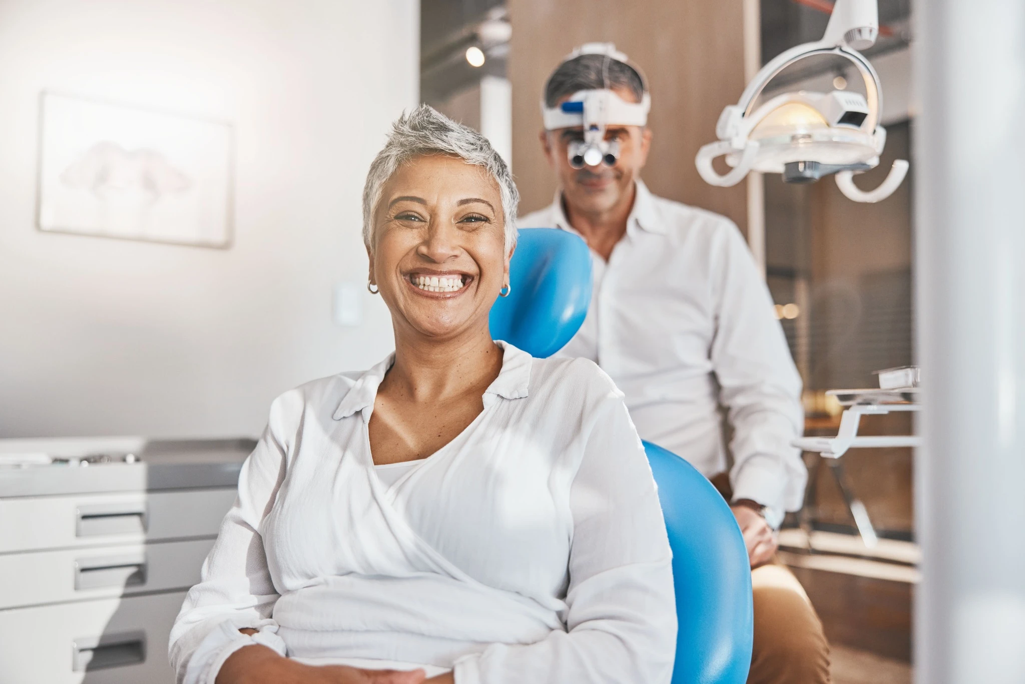 Happy mature patient smiling after care